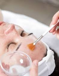 Specialised skin care being applied to womans face.